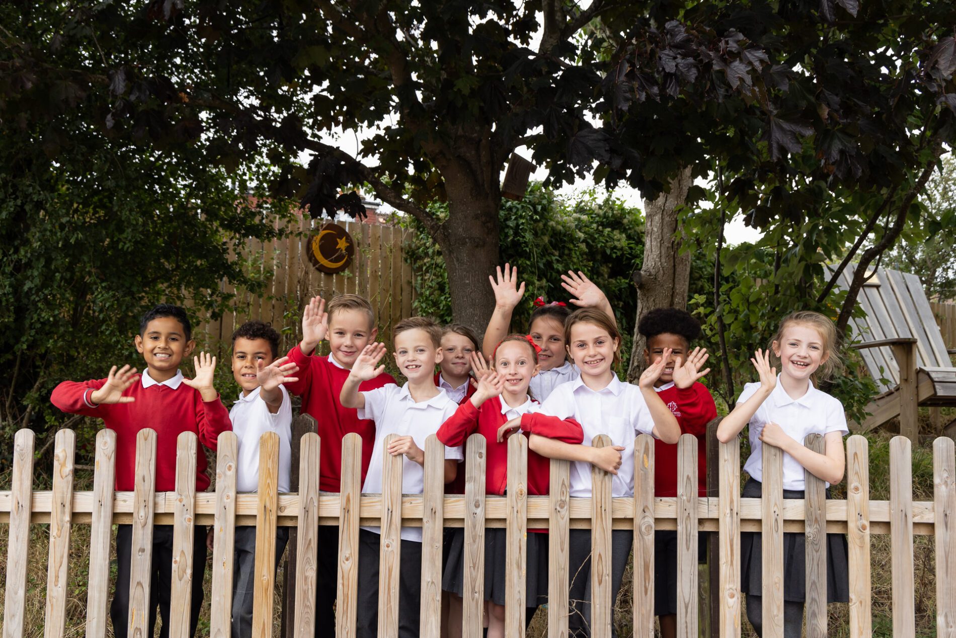 pupils smiling and waving at st botolphs primary school
